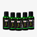 Five green bottles with black caps on a white background